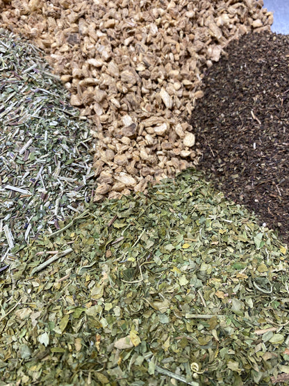 Ginger, Tulsi, Skullcap, Passionflower herbs poured next to eachother in a large mass.  